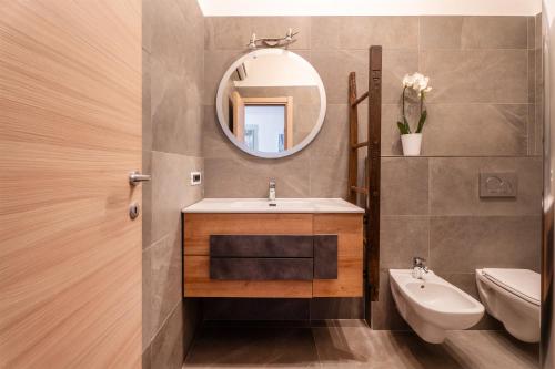 a bathroom with a sink and a mirror at Mont&Lac Lake View Apartment in Limone in Limone sul Garda