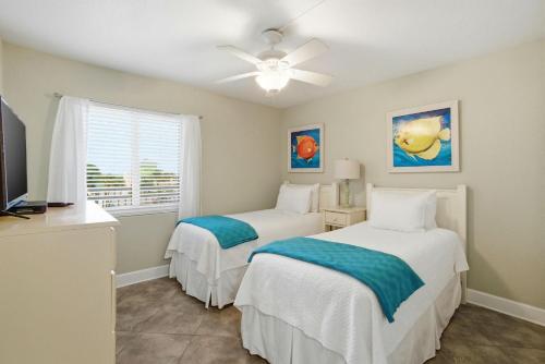 two beds in a room with a window at SeaSpray West 303-Gulf Front in Perdido Key