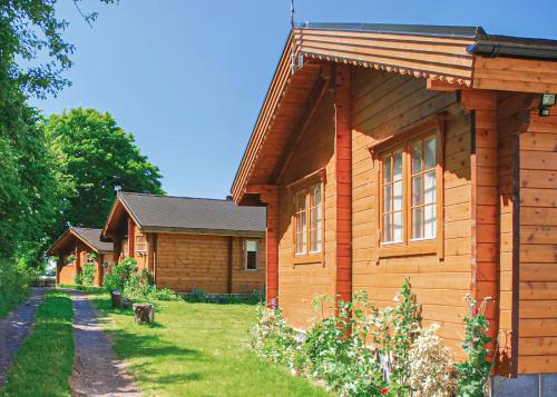 a wooden house with a grass yard next to it at Home Farm in Stillingfleet