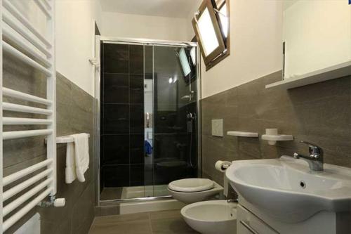 a bathroom with a shower and a sink and a toilet at Maresidence Rooms & Breakfast in Torre Pali