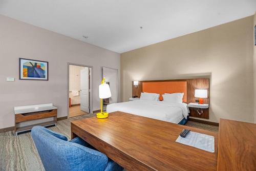 a hotel room with a bed and a table and chairs at Hampton Inn & Suites New Braunfels in New Braunfels
