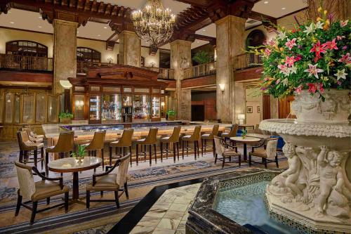 a restaurant with tables and chairs and a bar at Peabody Memphis in Memphis