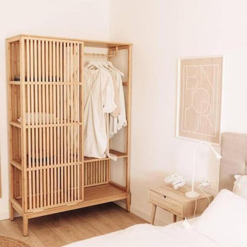 a bedroom with a wooden wardrobe and a bed at Villa Sunrise Labin Istria - a smile every day in Nedeščina