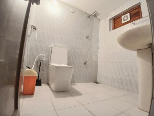 a bathroom with a toilet and a sink at Rose Apple Hostel in Ahangama