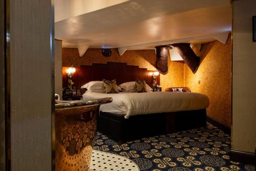 a hotel room with a large bed and a bathroom at Ocean Mist Leith in Edinburgh