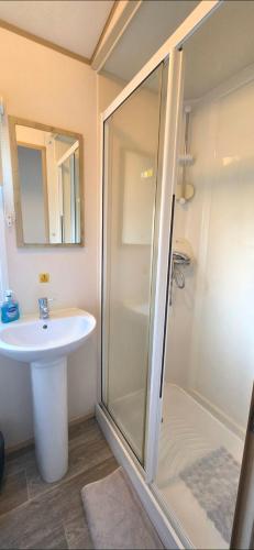 a bathroom with a shower and a sink at Shellie's Summer Breeze Retreat in Heysham