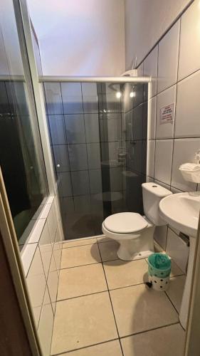 a bathroom with a toilet and a shower and a sink at Pousada Lua Nova in Paraty