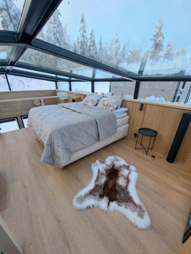 a bedroom with a bed and a large window at Levi Lapland Luxury Igloos C in Levi