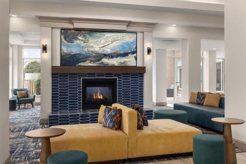 a living room with a couch and a fireplace at Hilton Garden Inn Washington DC/Greenbelt in Greenbelt