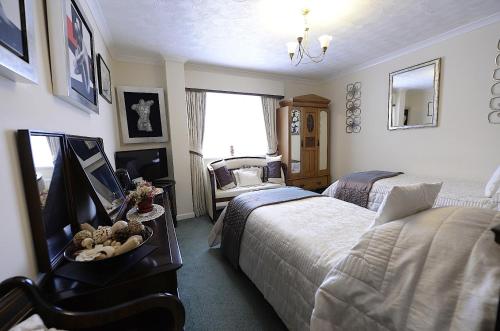 a bedroom with two beds and a window at Meryan House Hotel in Taunton