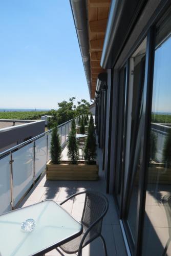 a balcony with a table and chairs on a building at Gästehaus Rebenhof in Neustadt an der Weinstraße