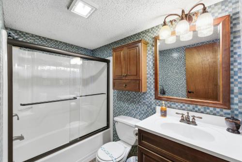 a bathroom with a shower and a sink and a toilet at Cozy Camelback, Pocono Retreat with Mountain Views! in Tannersville