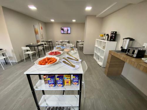 a kitchen with a table with food on it at Hotel Seoul in Mexico City