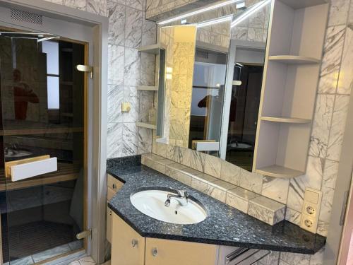 a bathroom with a sink and a mirror at Viktoria`s Penthouse in Bad Breisig