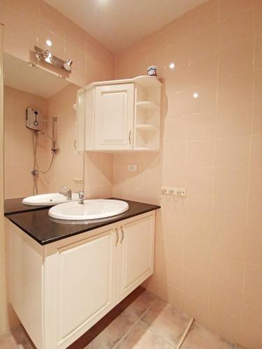 a bathroom with a white sink and a shower at Pool Villa 91 in Ban Nong Pru