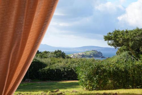 a view of the ocean from a house at Cala Del Faro House in Arzachena