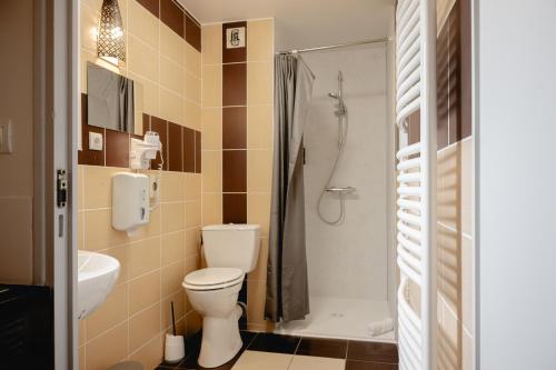 a bathroom with a toilet and a sink and a shower at Brit Hotel L'Arrivée Guingamp in Guingamp