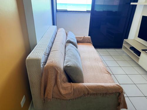 a large couch in a room with a door at Neo 2.0 in Maceió