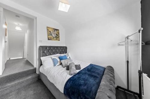 a bedroom with a large bed with blue pillows at Spacious 3 bedroom home, sleeps 8, Parking, Central Rochester in Rochester