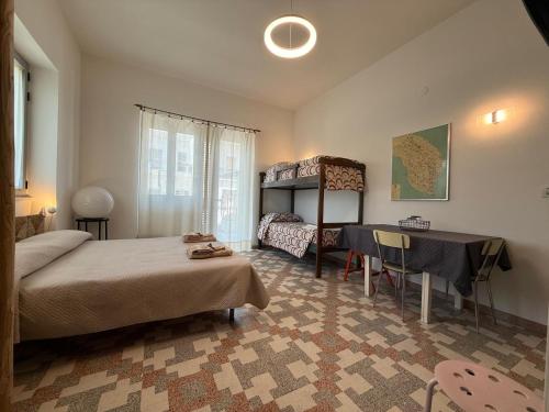 a bedroom with a bed and a desk and a table at casa surano in Diso