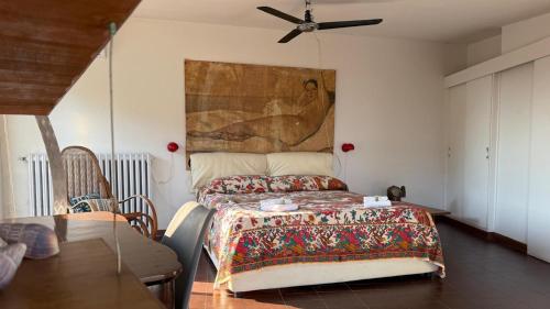 a bedroom with a bed with a painting on the wall at Villa Luce by Italy Home eXperience in Santa Marinella