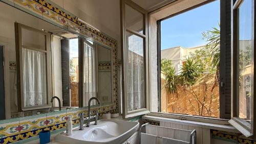 a bathroom with two sinks and a large window at Villa Luce by Italy Home eXperience in Santa Marinella