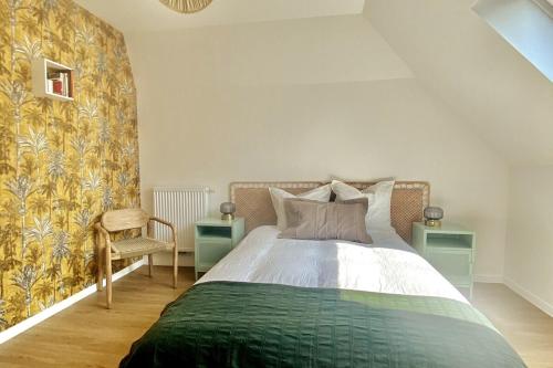 a bedroom with a bed and two tables and a chair at Appartement Vue Château - parking privé - 80m2 - Vaugueux Caen in Caen