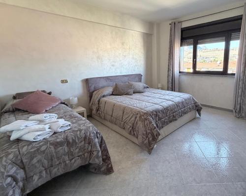 a bedroom with two beds and a window at Casa Baccanico - a due passi da autostazione in Avellino