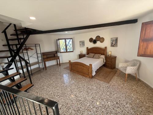 a bedroom with a bed and a staircase in it at El Molino de Valverde in Elche