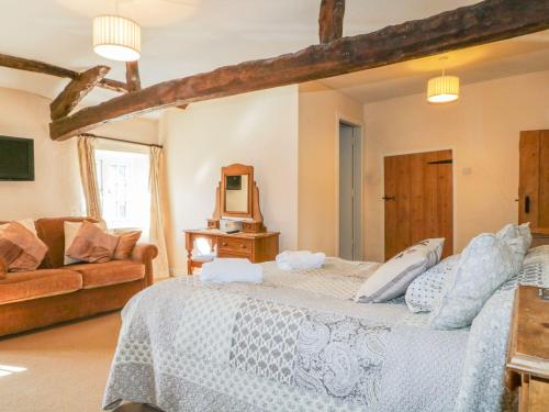 a large bedroom with a bed and a couch at The Farmhouse in Keswick