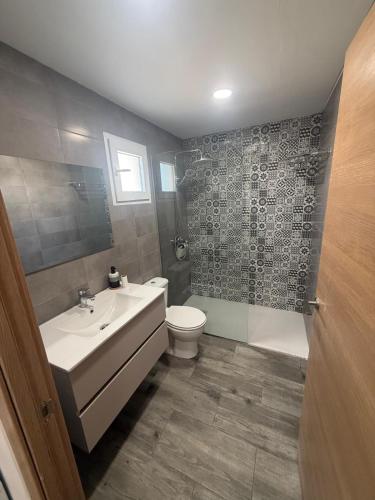 a bathroom with a sink and a toilet at El Molino de Valverde in Elche