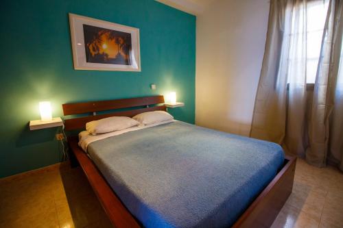 a bedroom with a large bed with two pillows at Casa Julia in Agaete