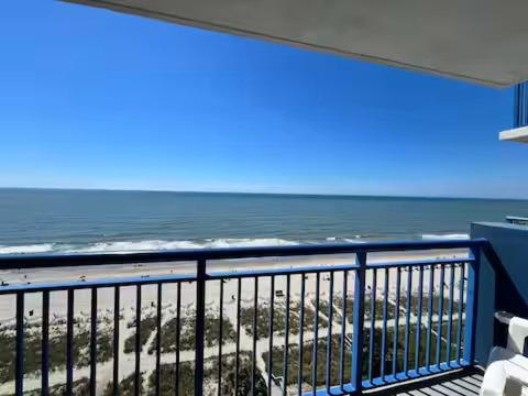 a balcony with a view of the beach and the ocean at Oceanfront 2BR King Suite Atlantica Resort in Myrtle Beach