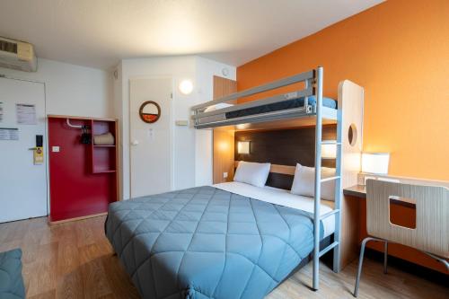 a bedroom with a bed and a bunk bed at Premiere Classe Roissy Aéroport Charles De Gaulle in Roissy-en-France