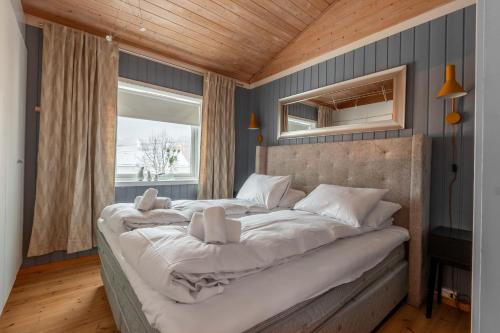 a large bed in a room with a window at Tromsø Panorama in Tromsø