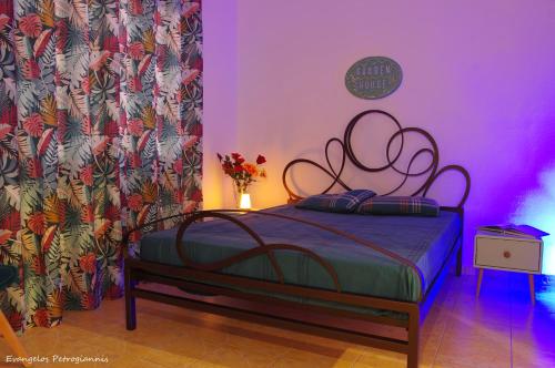 a bedroom with a bed in a purple room at Garden house in Amarynthos