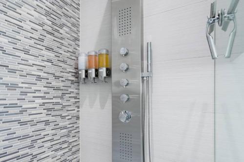a shower in a bathroom with a glass shower backdoor at Modern, Dog Friendly Apartment with a Private Patio in Dallas