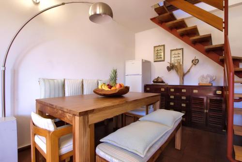 a dining room with a wooden table and chairs at 20 passi dalla spiaggia - Panoramic Duplex in Porto Rotondo