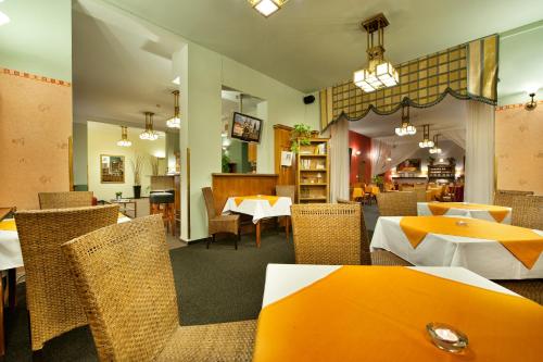 un comedor con mesas y sillas en un restaurante en Aron en Praga