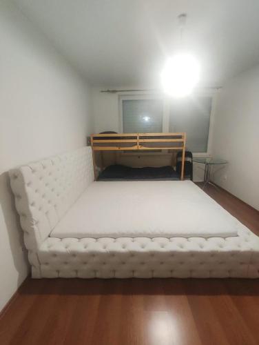a large white bed in a small room at YCZ Praha in Prague
