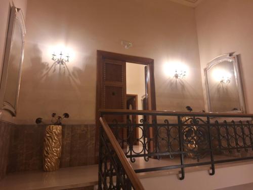 a staircase with a mirror on the wall and lights at Dimora Charleston Lecce parcheggio privato in loco gratis in Lecce