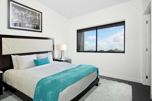 a bedroom with a large bed and a window at Scarlett Near Mount Zion Laguit Padilla in Bugallon