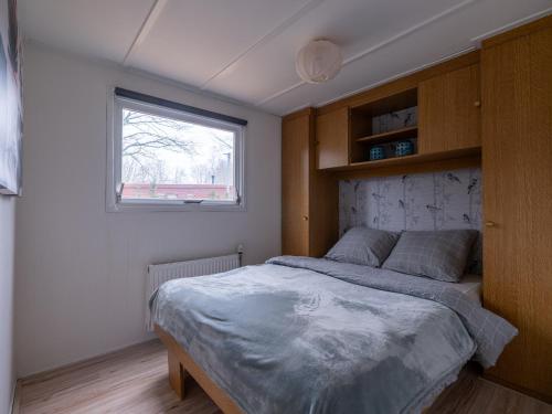 a bedroom with a bed and a window at Ermway Cottage in Erm