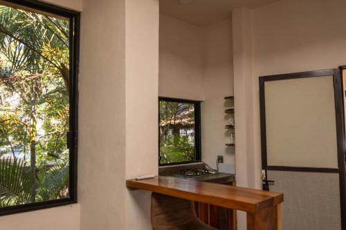 a bathroom with a mirror and a sink at La Punta SurfHouse in Brisas de Zicatela