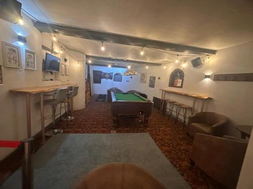 a billiard room with a pool table and a bar at Manor Inn Galmpton in Brixham