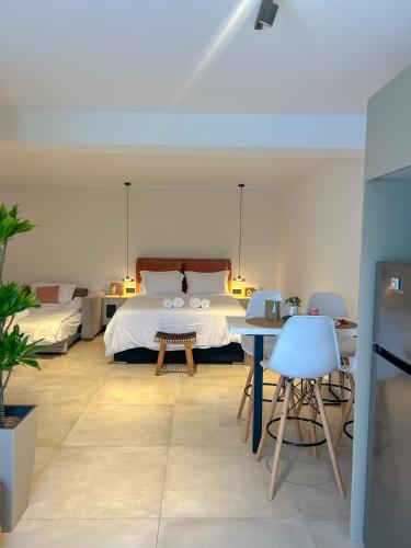 a bedroom with a bed and a table and chairs at Apademia Comfort Studio 45 sqm in Skiros
