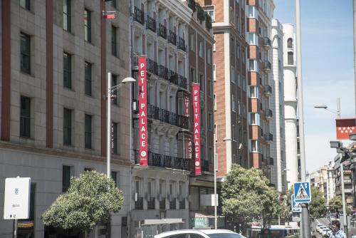 a building with red signs on the side of it at Petit Palace Plaza España in Madrid