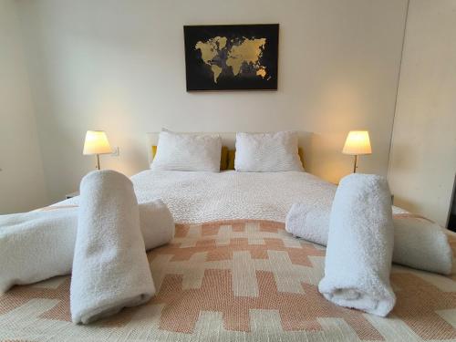 a bedroom with a bed with white sheets and pillows at Spacious Quiet Pyrenees View Garage in Pau