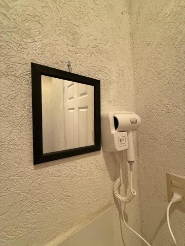 a mirror on a wall with a hair dryer at Refugio de mar y arena in Acapulco