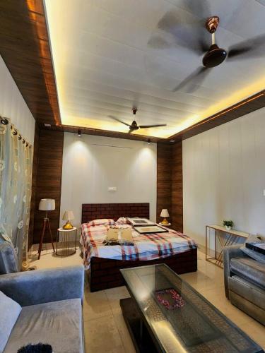 a bedroom with a bed and a ceiling fan at The Casa Bella in Faridabad